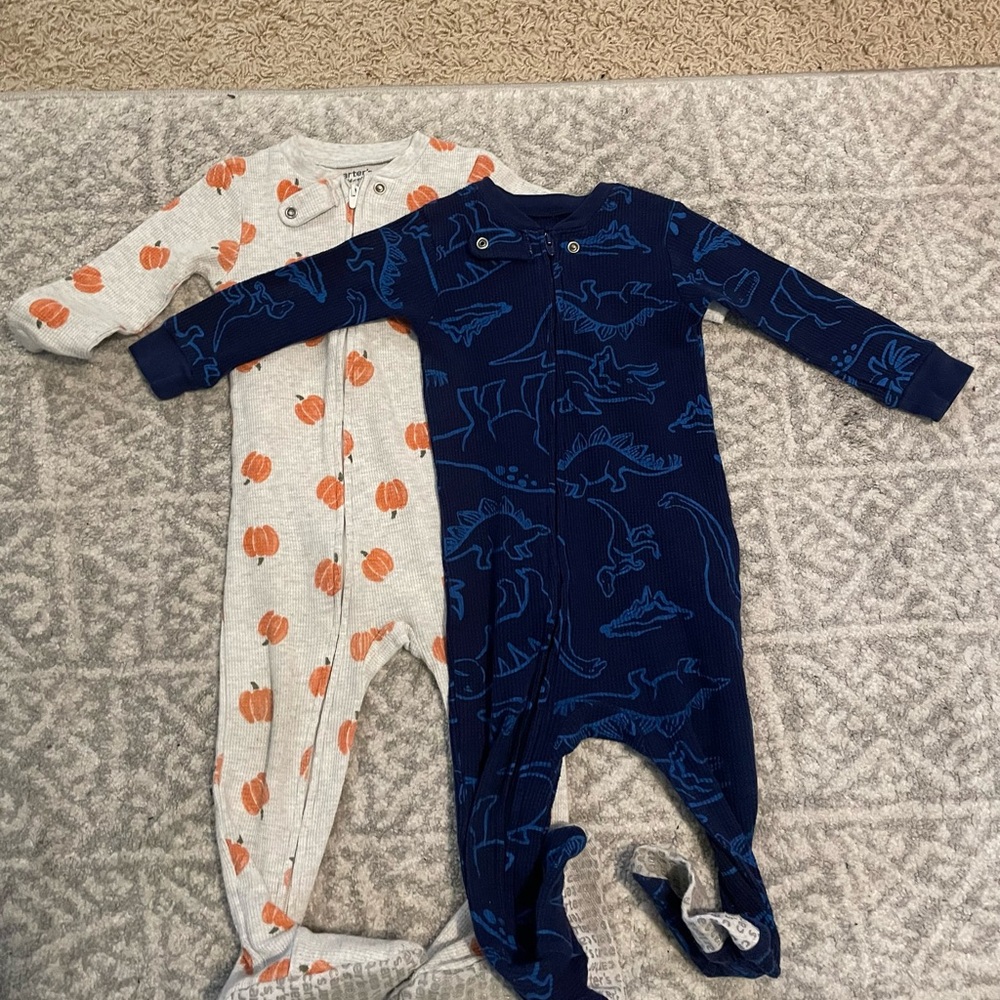 Two long sleeve onesies/ footie pajamas by Carters in a size 12 months.